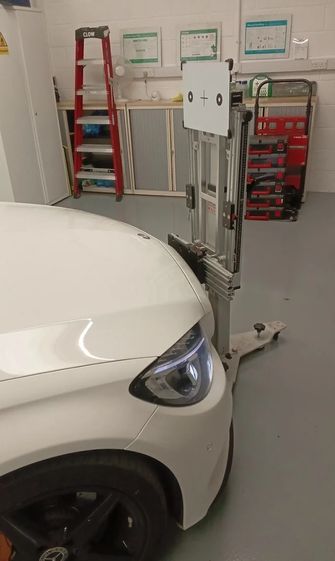 ADAS calibration technician using OEM-grade diagnostic equipment in a UK workshop